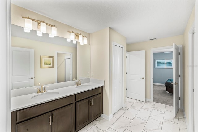 bathroom with vanity and a textured ceiling