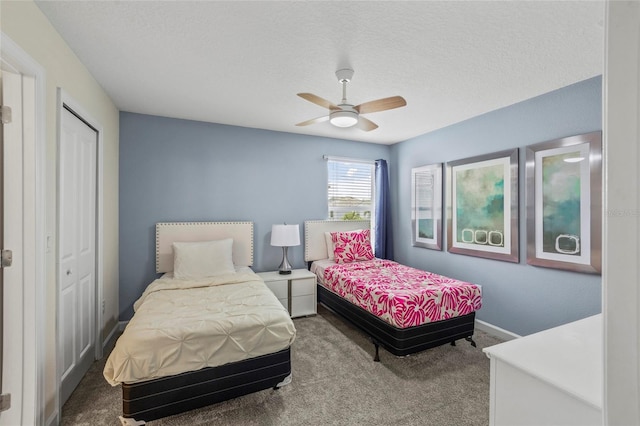 bedroom featuring ceiling fan, a closet, a textured ceiling, and carpet