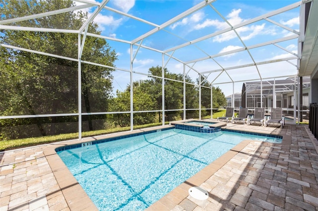 view of swimming pool with an in ground hot tub, a patio, and glass enclosure