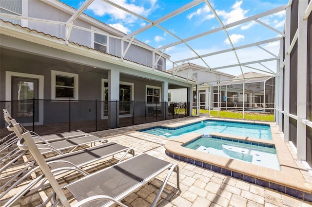 view of swimming pool featuring an in ground hot tub, a lanai, and a patio