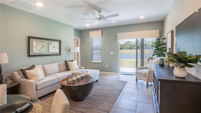 tiled living room featuring ceiling fan