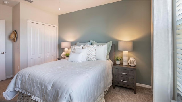 bedroom with light carpet and a closet