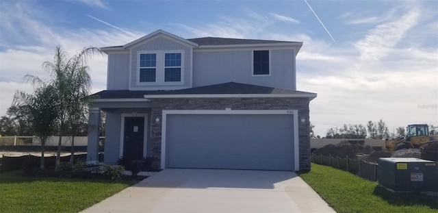 view of front facade featuring a garage and a front lawn