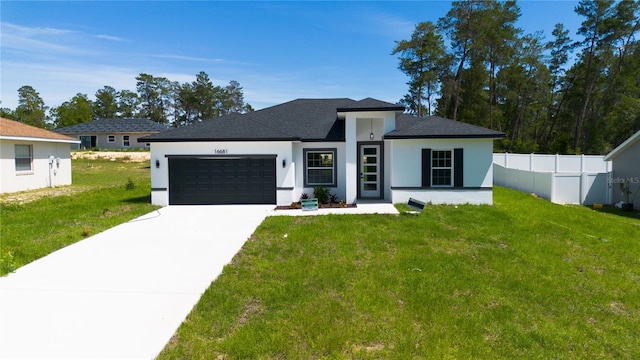 view of front facade with a garage and a front yard