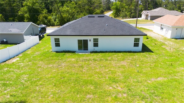 back of house with a lawn