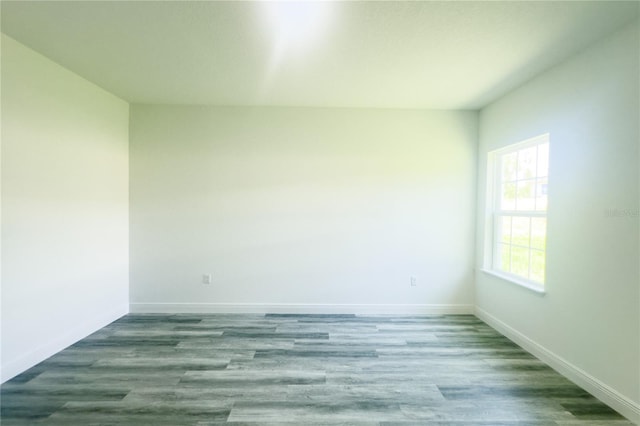 unfurnished room with hardwood / wood-style flooring