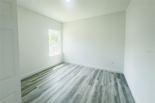 spare room with wood-type flooring