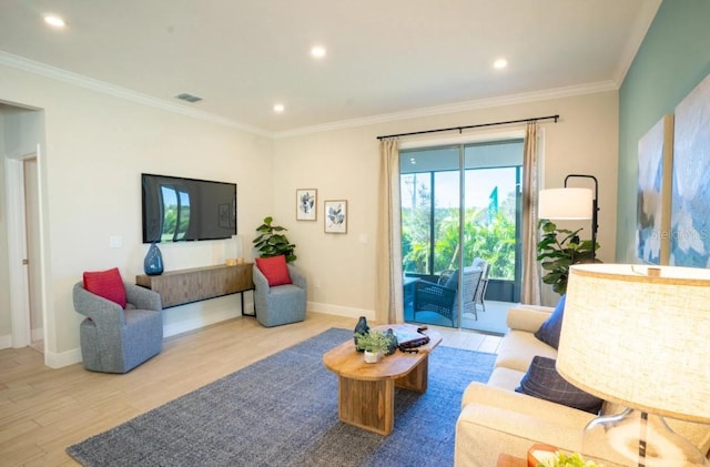 living room with ornamental molding and light hardwood / wood-style floors