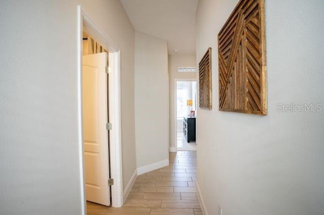 corridor with light hardwood / wood-style floors