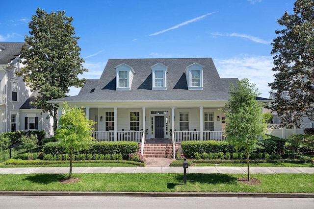 new england style home featuring a porch