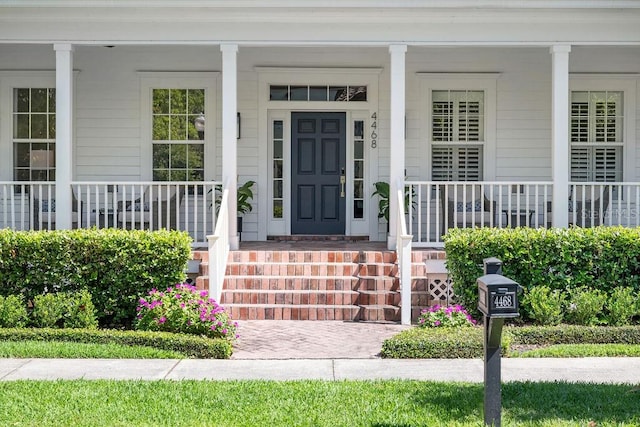 entrance to property featuring covered porch