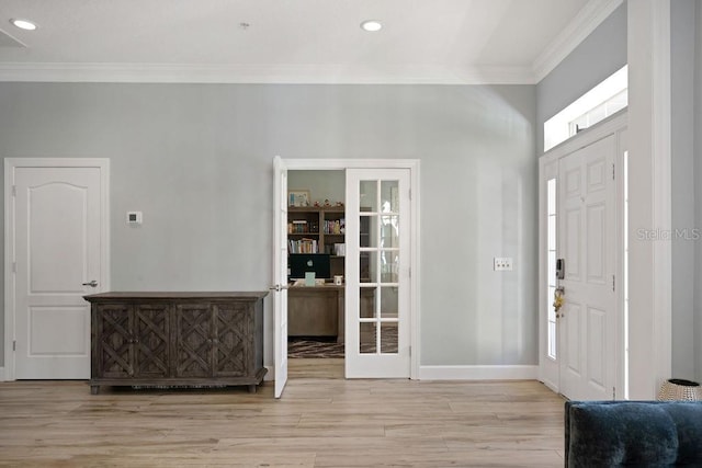 entrance foyer featuring ornamental molding and light wood-type flooring