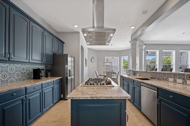 kitchen featuring blue cabinets, appliances with stainless steel finishes, light tile floors, range hood, and backsplash