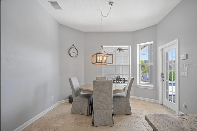 tiled dining space with a notable chandelier