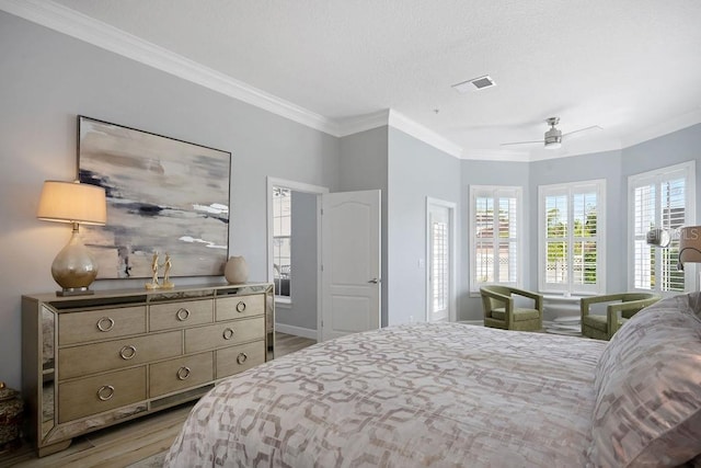 bedroom with wood-type flooring, ceiling fan, and crown molding