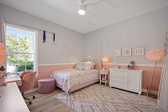 bedroom with light hardwood / wood-style floors and ceiling fan