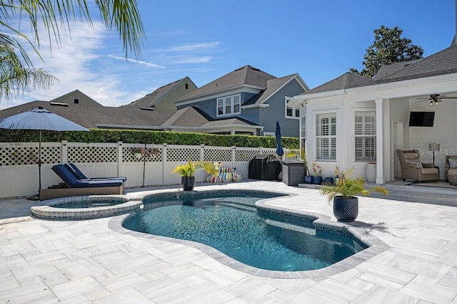 view of swimming pool with a patio, ceiling fan, and an in ground hot tub