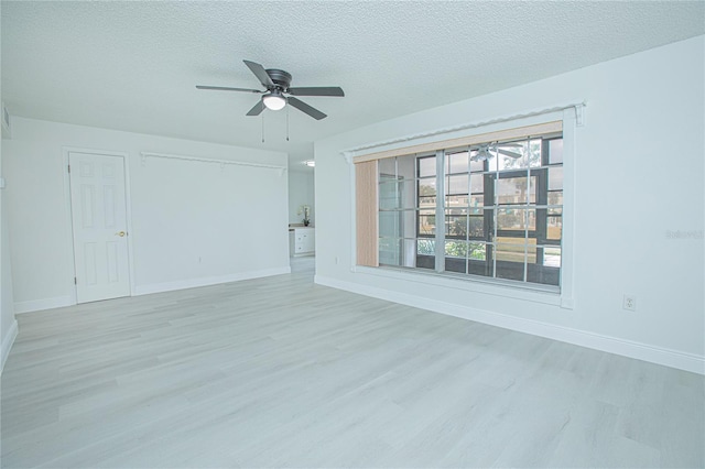 unfurnished living room featuring light wood-type flooring, ceiling fan, and a textured ceiling