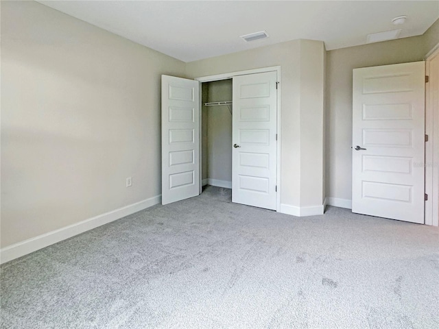 unfurnished bedroom with carpet flooring and a closet