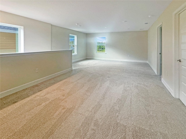 carpeted spare room with baseboards