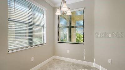 spare room featuring an inviting chandelier