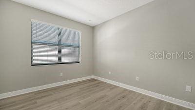 spare room with light hardwood / wood-style flooring