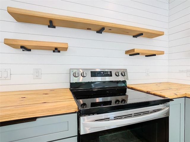 kitchen featuring butcher block countertops and stainless steel electric range