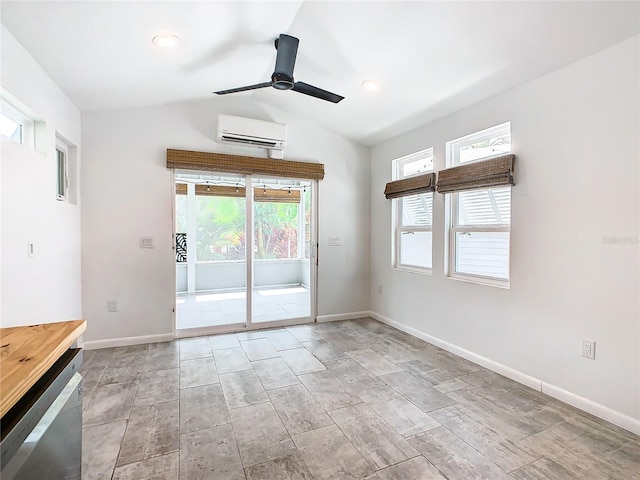 empty room featuring a wealth of natural light, a wall mounted AC, ceiling fan, and light tile floors