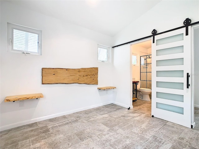 empty room with a barn door and tile floors