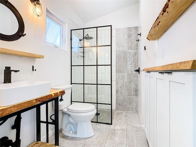 bathroom with vaulted ceiling, an enclosed shower, tile floors, toilet, and large vanity