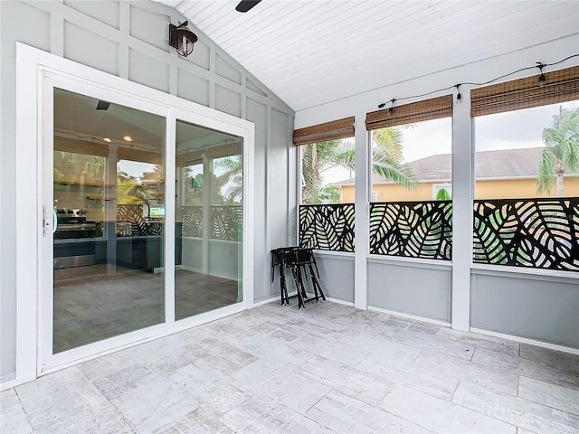 unfurnished sunroom with vaulted ceiling