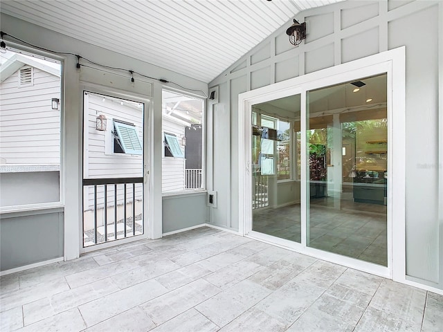 unfurnished sunroom featuring vaulted ceiling and wood ceiling