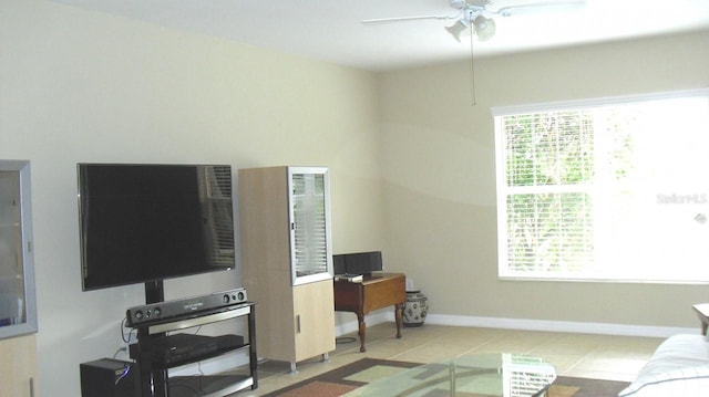 tiled living room with ceiling fan