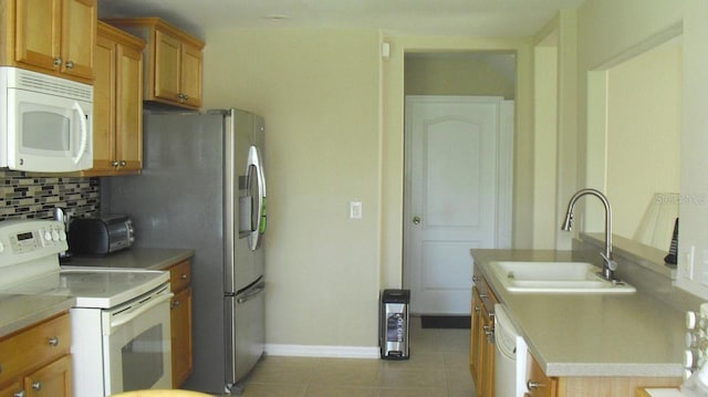 kitchen featuring sink, white appliances, decorative backsplash, and light tile patterned floors