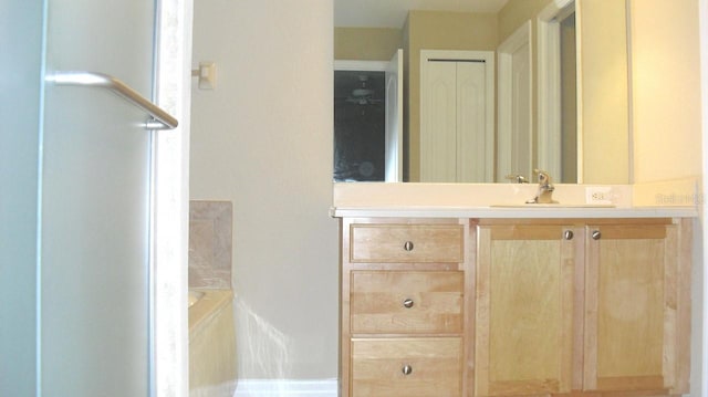 bathroom featuring vanity and a bath