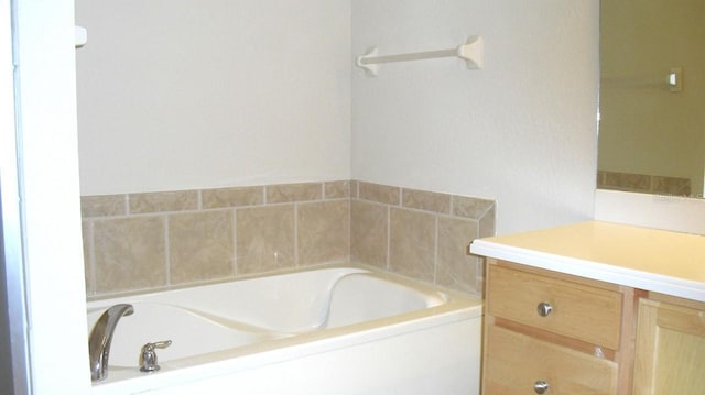 full bathroom with a bath and vanity