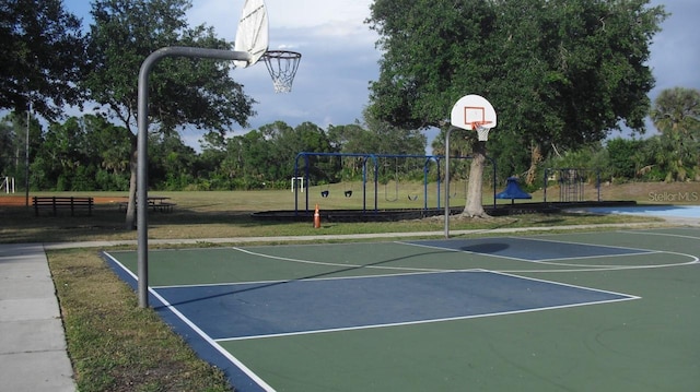 view of sport court featuring community basketball court and playground community