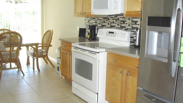 kitchen with white appliances, baseboards, light tile patterned flooring, light countertops, and tasteful backsplash