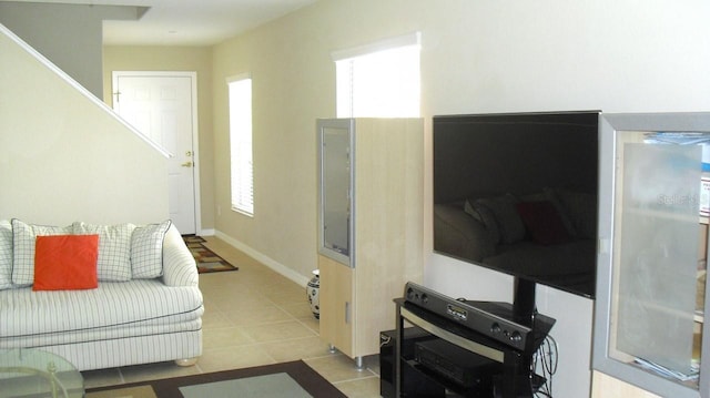 living area featuring tile patterned flooring and baseboards