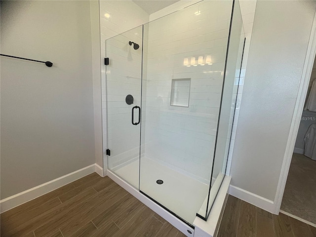 bathroom with a shower with door