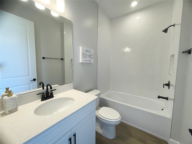 full bathroom with vanity, hardwood / wood-style flooring,  shower combination, and toilet