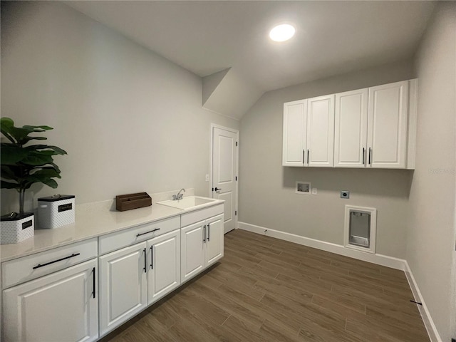 clothes washing area featuring sink, dark wood-type flooring, hookup for a washing machine, cabinets, and hookup for an electric dryer