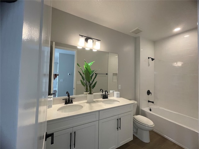 full bathroom featuring hardwood / wood-style flooring, shower / tub combination, vanity, and toilet