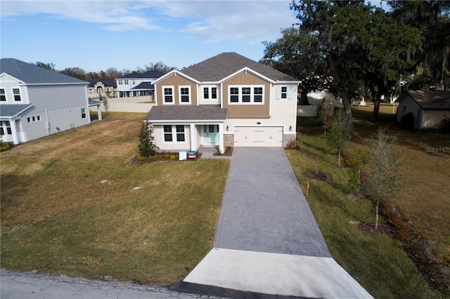 view of front of home featuring a garage and a front lawn