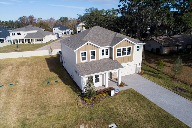 view of front of property with a garage and a front lawn