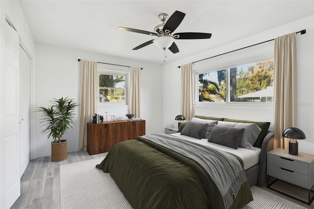 bedroom featuring ceiling fan, a closet, and light hardwood / wood-style flooring