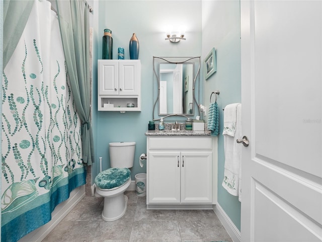 bathroom featuring vanity, toilet, and tile floors