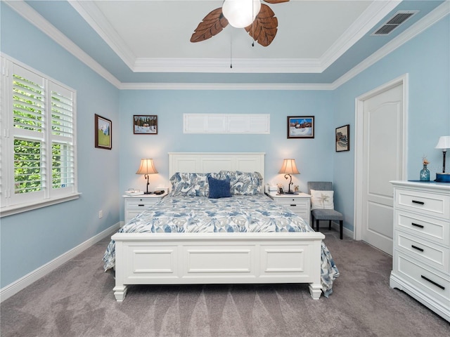 carpeted bedroom featuring a raised ceiling, ceiling fan, and crown molding