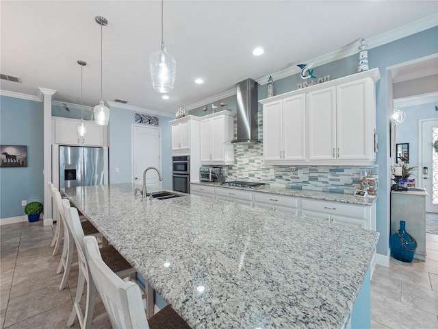 kitchen with a spacious island, a kitchen breakfast bar, tasteful backsplash, wall chimney exhaust hood, and appliances with stainless steel finishes