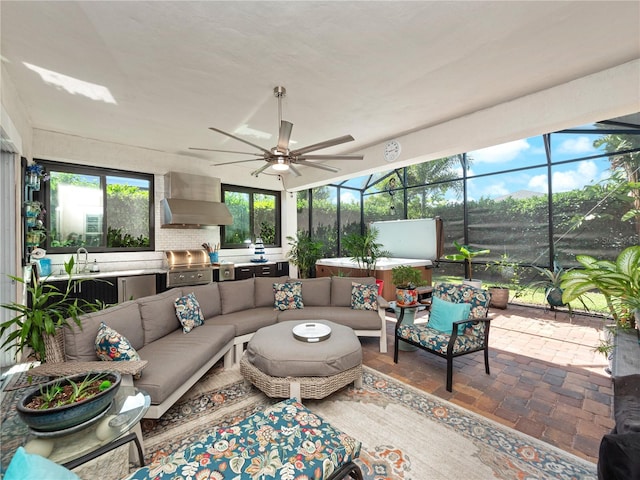 sunroom / solarium with sink and ceiling fan